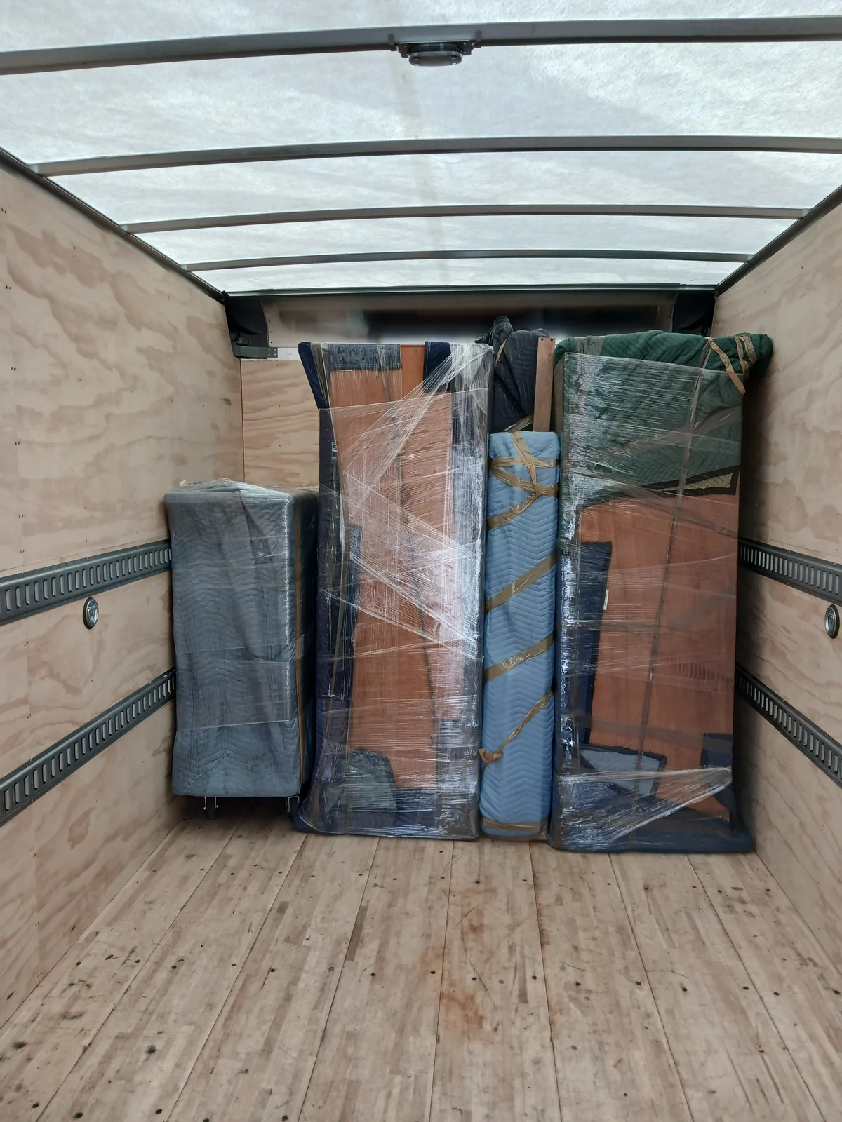 Protected furniture packed securely inside a moving truck.