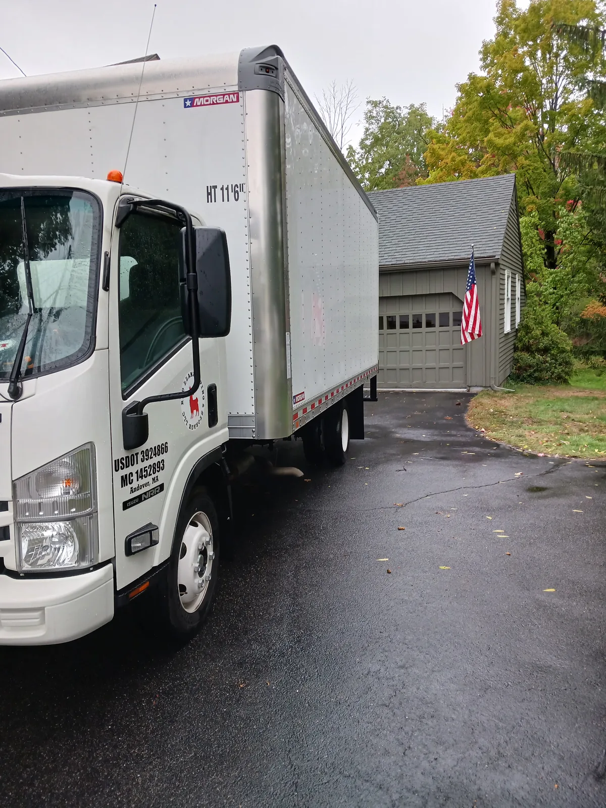 Red Llama moving truck parked at a residential home.