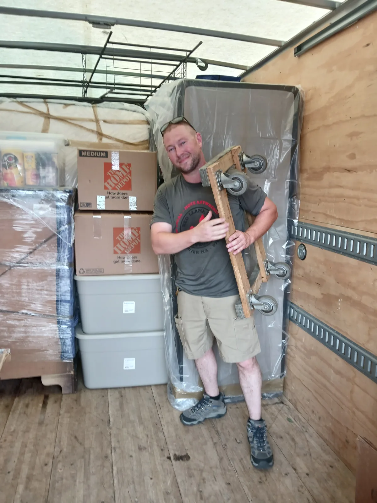Red Llama mover with boxes inside the moving truck.